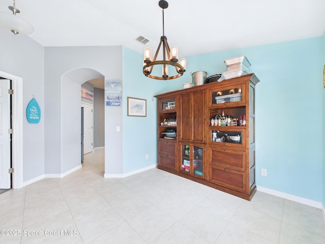 2515 SE Marquez Ave SE, Palm Bay, FL 32909 - spare room with baseboards, arched walkways, a notable chandelier, and visible vents
