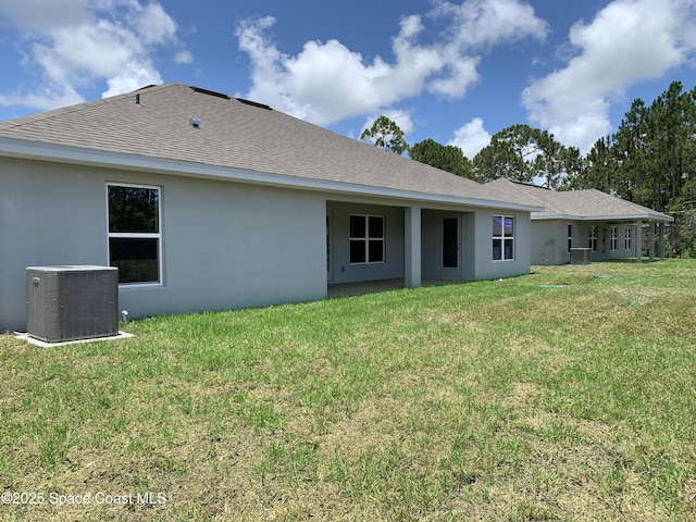2205 Sans Souci Ave SE, Palm Bay, FL 32909 - rear view of property with stucco siding, a lawn, and a shingled roof