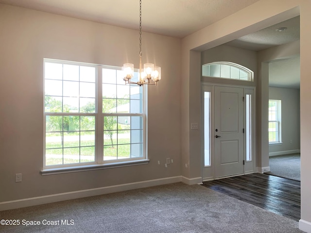 2205 Sans Souci Ave SE, Palm Bay, FL 32909 - carpeted entrance foyer featuring baseboards and a chandelier