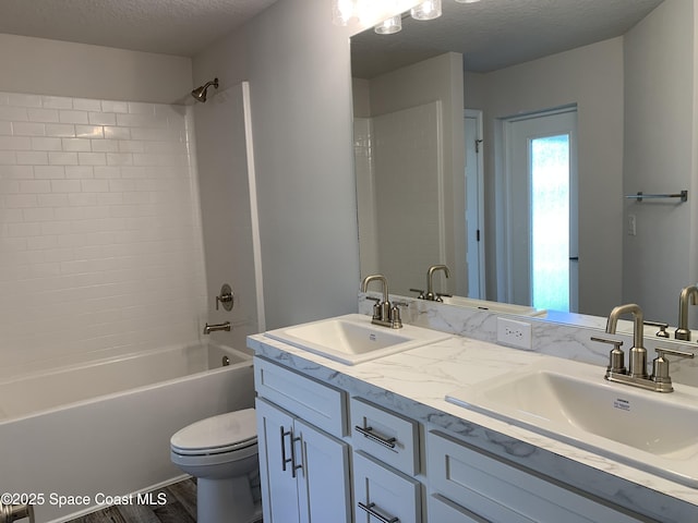 2205 Sans Souci Ave SE, Palm Bay, FL 32909 - full bath with double vanity, shower / bath combination, a textured ceiling, and wood finished floors
