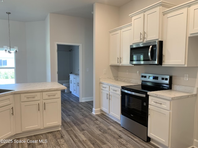 2205 Sans Souci Ave SE, Palm Bay, FL 32909 - kitchen featuring appliances with stainless steel finishes, dark wood-style flooring, a chandelier, and white cabinets