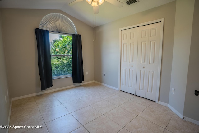 3780 Starlight Ave, Merritt Island, FL 32953 - unfurnished bedroom featuring visible vents, baseboards, light tile patterned floors, a closet, and vaulted ceiling