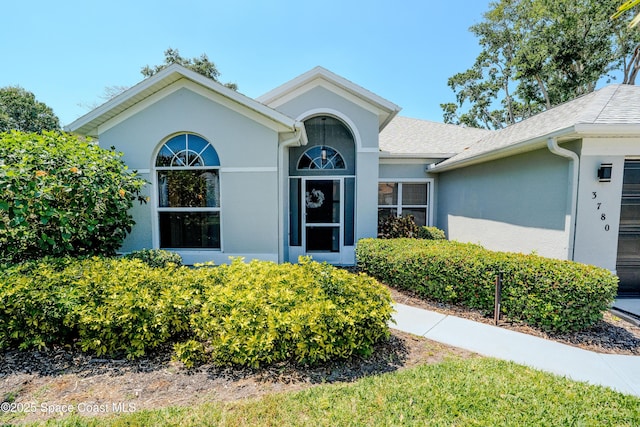 3780 Starlight Ave, Merritt Island, FL 32953 - view of front of house with roof with shingles and stucco siding