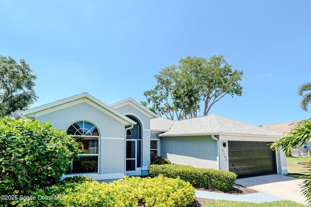 3780 Starlight Ave, Merritt Island, FL 32953 - ranch-style home featuring a garage, stucco siding, and concrete driveway