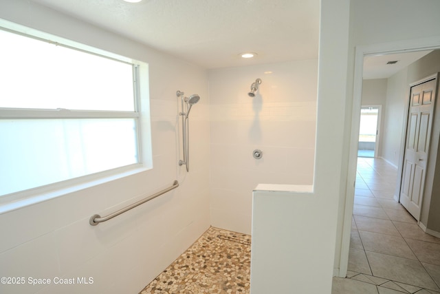 3780 Starlight Ave, Merritt Island, FL 32953 - full bath with a wealth of natural light, tile patterned flooring, and a tile shower