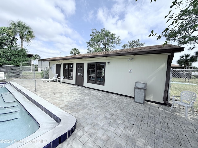 back of property featuring a patio and fence