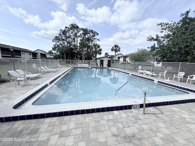 community pool featuring a patio area and fence