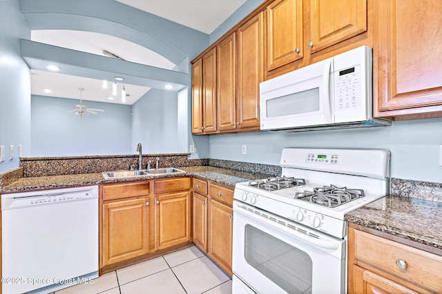 8657 Villanova Dr Unit 901, Cape Canaveral, FL 32920 - kitchen featuring dark stone countertops, light tile patterned floors, a sink, ceiling fan, and white appliances