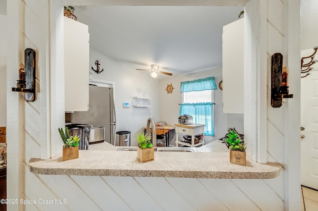 999 Jupiter Blvd NW, Palm Bay, FL 32907 - kitchen featuring a peninsula, freestanding refrigerator, a sink, and ceiling fan