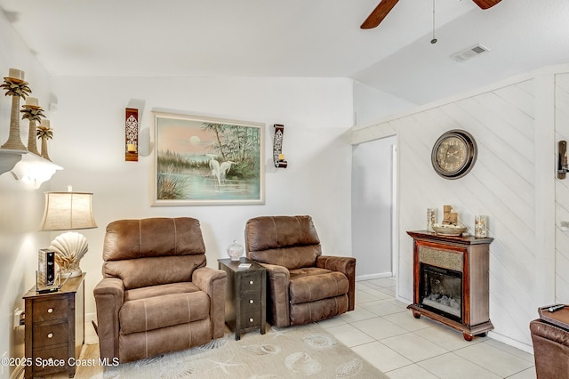 999 Jupiter Blvd NW, Palm Bay, FL 32907 - living area featuring visible vents, light tile patterned floors, ceiling fan, vaulted ceiling, and a glass covered fireplace