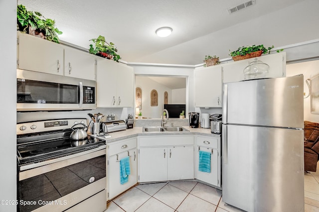 999 Jupiter Blvd NW, Palm Bay, FL 32907 - kitchen with light tile patterned floors, visible vents, appliances with stainless steel finishes, light countertops, and a sink