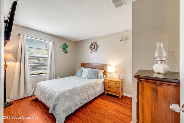 999 Jupiter Blvd NW, Palm Bay, FL 32907 - bedroom featuring wood finished floors and visible vents