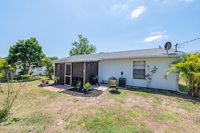 999 Jupiter Blvd NW, Palm Bay, FL 32907 - back of house featuring a yard and central AC unit