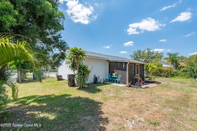 999 Jupiter Blvd NW, Palm Bay, FL 32907 - rear view of house with a yard and a sunroom