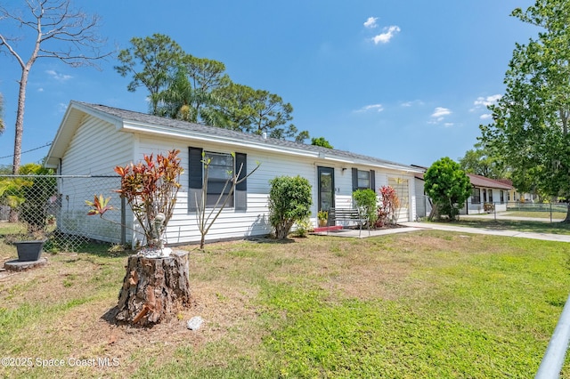 999 Jupiter Blvd NW, Palm Bay, FL 32907 - single story home with concrete driveway, a front yard, fence, and a garage