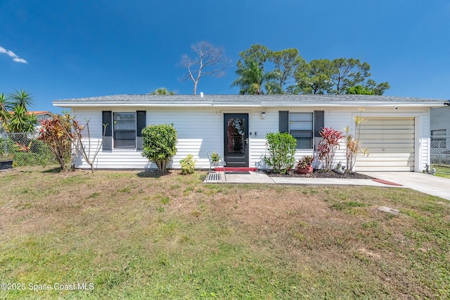 999 Jupiter Blvd NW, Palm Bay, FL 32907 - ranch-style house featuring a garage, driveway, fence, and a front lawn