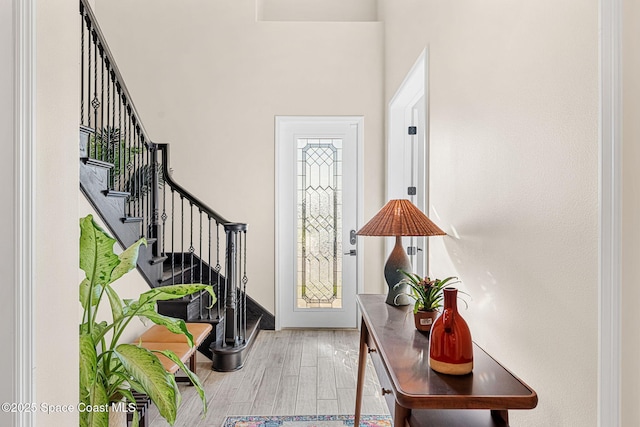 foyer with stairs and wood finished floors