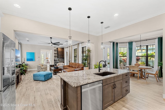 kitchen featuring appliances with stainless steel finishes, a sink, visible vents, and a healthy amount of sunlight