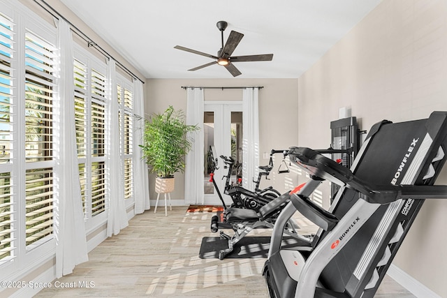 workout room with french doors, baseboards, a ceiling fan, and a healthy amount of sunlight