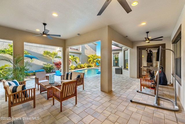 view of patio / terrace featuring an outdoor pool, ceiling fan, and an outdoor hangout area