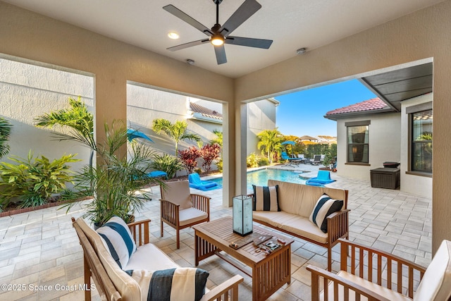 view of patio featuring an outdoor living space, an outdoor pool, and a ceiling fan