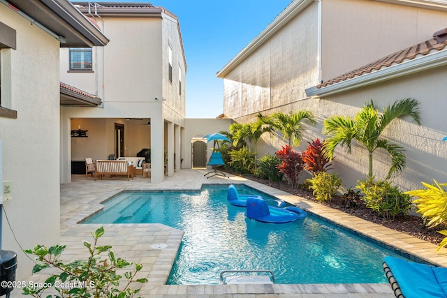view of swimming pool with a patio, a fenced in pool, and fence