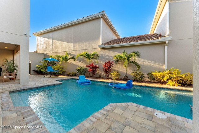 view of pool featuring a patio area, a fenced in pool, and fence