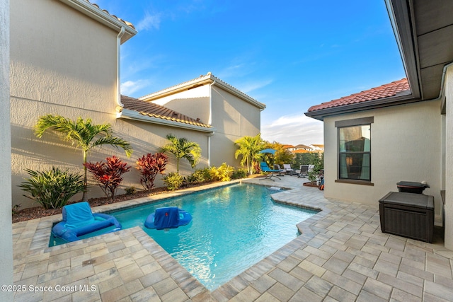 view of swimming pool featuring a fenced in pool and a patio