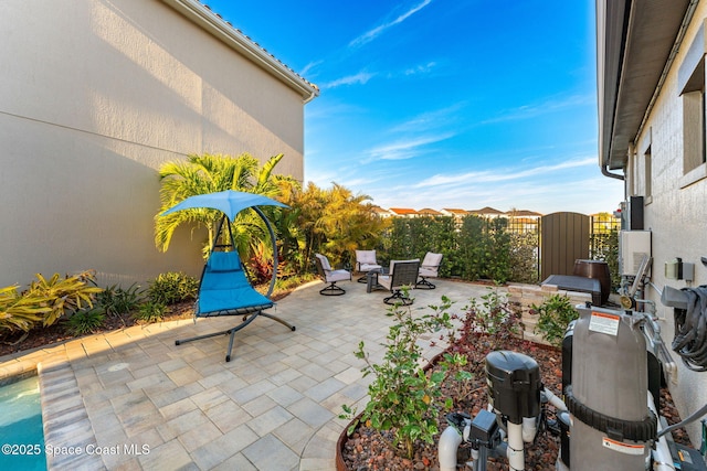 view of patio / terrace featuring fence and a gate