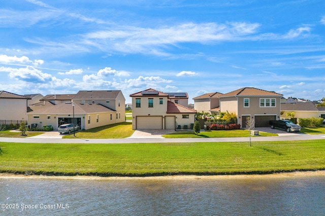 view of front of home with a front yard, a garage, a residential view, and driveway
