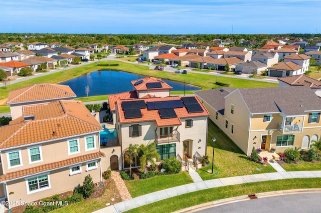 birds eye view of property featuring a water view and a residential view