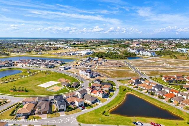 drone / aerial view featuring a water view and a residential view