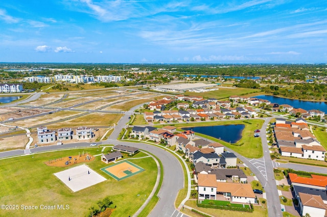 drone / aerial view featuring a water view and a residential view