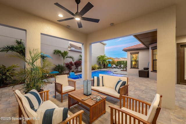 view of patio / terrace with an outdoor living space, an outdoor pool, and a ceiling fan