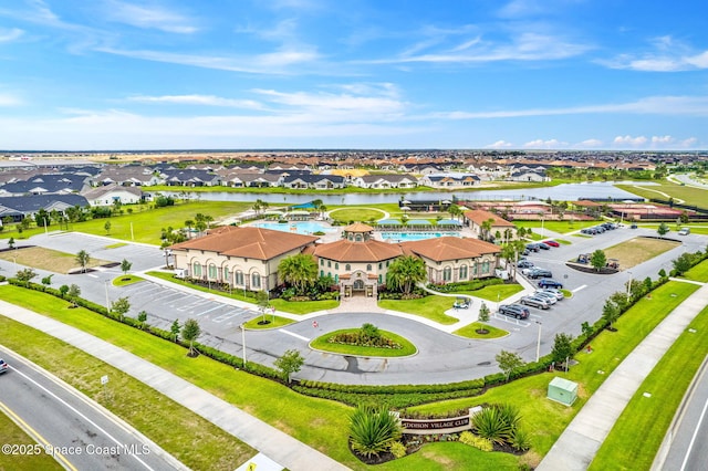 birds eye view of property with a water view and a residential view