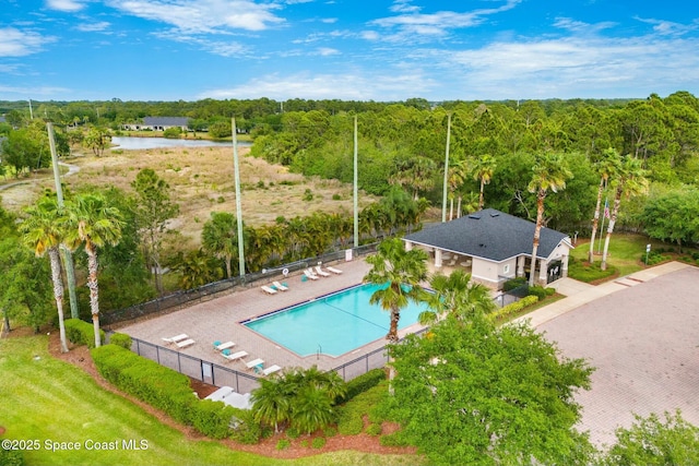 drone / aerial view with a forest view and a water view