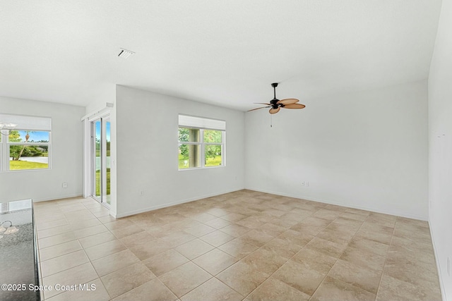 empty room featuring visible vents, ceiling fan, light tile patterned floors, and baseboards