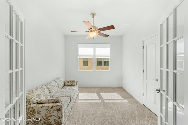 sitting room featuring carpet, french doors, visible vents, and a ceiling fan