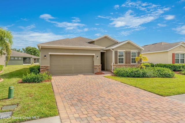 ranch-style house with stucco siding, decorative driveway, a front yard, stone siding, and a garage