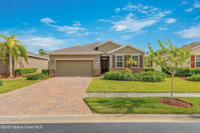 view of front facade featuring an attached garage, a front lawn, decorative driveway, and stucco siding