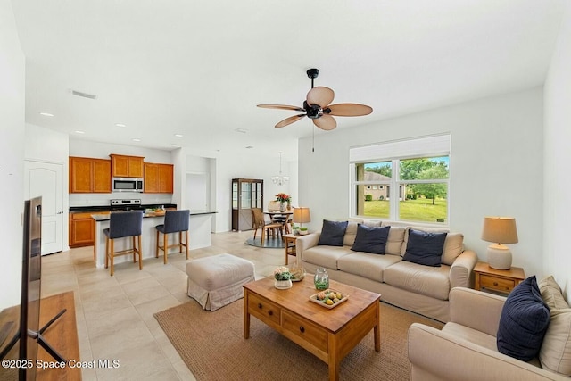 living room featuring light tile patterned floors, a ceiling fan, visible vents, and recessed lighting