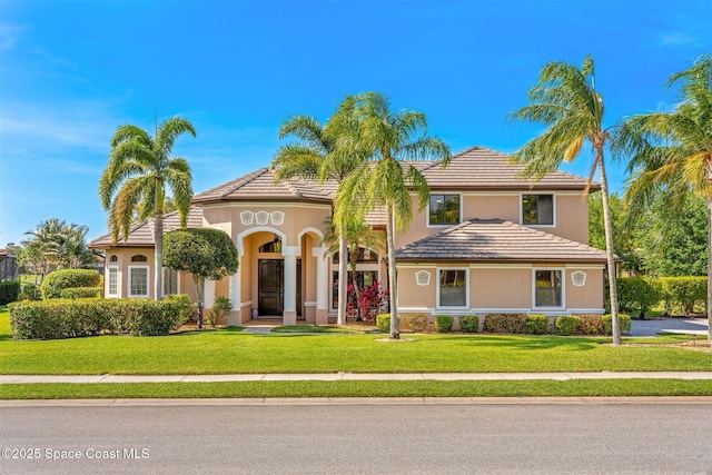 mediterranean / spanish-style home with a front yard and stucco siding