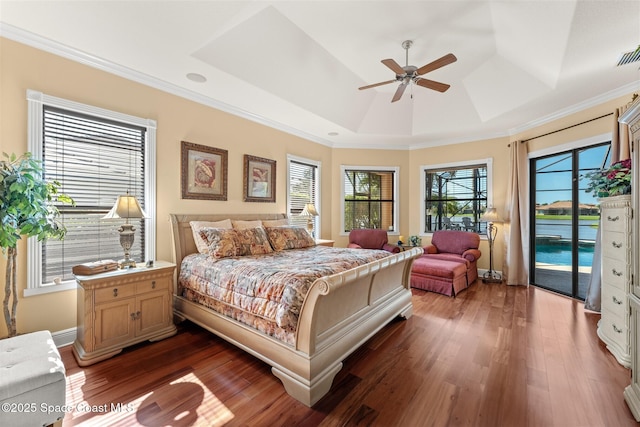 bedroom featuring crown molding, access to outside, a raised ceiling, and dark wood finished floors
