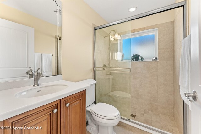 full bath featuring toilet, a stall shower, vanity, and recessed lighting