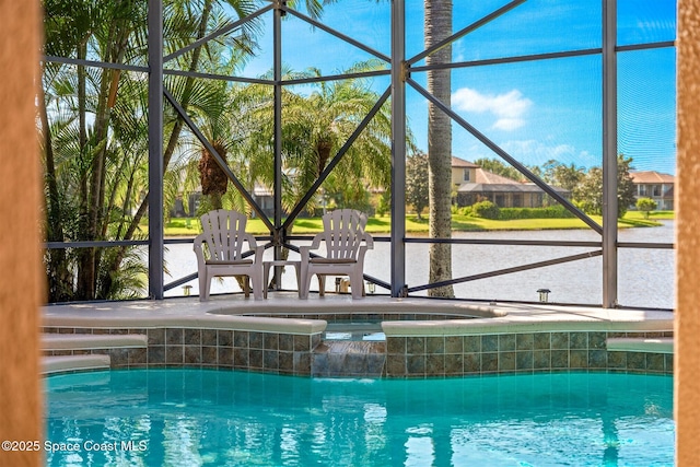 pool featuring an in ground hot tub and glass enclosure