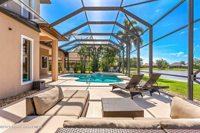 view of pool with an outdoor living space, a pool with connected hot tub, a water view, a patio, and a lanai