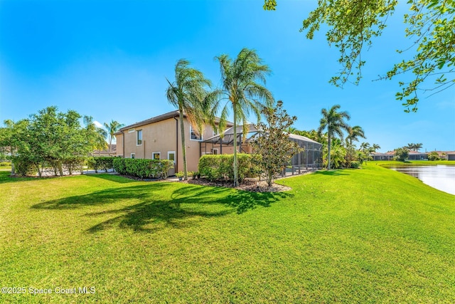 view of yard featuring a water view and a lanai