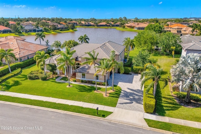 drone / aerial view with a water view and a residential view