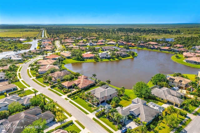 drone / aerial view featuring a water view and a residential view