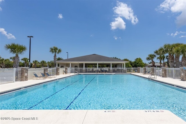 community pool featuring a patio area and fence
